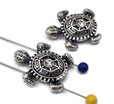Rhinestone turtle beads in shiny silver finish offer a mix of sparkle and artisan design. Each bead features a textured shell and realistic flippers that highlight ocean life’s beauty. Use them as accents or centerpiece beads for beach‑inspired bracelets, necklaces, and earrings. Perfect for coastal or bohemian jewelry collections that value shine and meaning.
