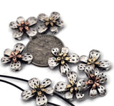 Silver flower 2‑hole slider beads with embossed texture and copper or gold centers add blooming brilliance to handmade jewelry. The dual threading holes ensure flat alignment in double‑strand bracelets and chokers. Perfect for floral‑themed, vintage, or decorative jewelry pieces that sparkle with elegance and craftsmanship.