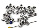Silver sea turtle 2‑hole slider beads with engraved shells and smooth body shapes make ideal focal points in double‑strand bracelets. Their luminous finish adds shine, while the detailed texture evokes the beauty of marine life. Perfect for boho, beach, or tropical jewelry designs that celebrate the ocean’s calm and resilience.
