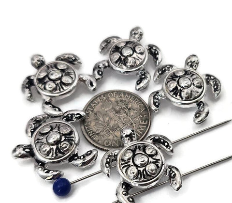 These silver turtle 2‑hole slider beads feature detailed spiral shell carvings and raised limbs for authentic ocean character. Their dual threading holes ensure symmetrical alignment for bracelets and chokers. A perfect choice for coastal, summer, or spiritual jewelry inspired by nature and the sea turtle’s symbolism of strength and calm.