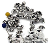 These polished silver turtle 2‑hole slider beads shimmer with swirling shell patterns and a silver tone that catches the light beautifully. Designed for flat, even alignment in double‑strand bracelets or chokers, they’re durable, symbolically rich, and ideal for artisans creating ocean or nature‑inspired jewelry collections.