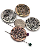 These ornate medallion 2‑hole beads showcase intricate floral filigree that reads like lace. Finished in antique silver, brass, and copper, each focal is lightweight yet bold. Dual slider holes keep designs straight in bracelets and chokers, preventing twisting. A versatile choice for boho chic, Renaissance, and boutique jewelry with heirloom style.
