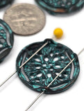 These patina medallion 2‑hole beads deliver instant vintage charm. A turquoise‑green wash highlights the floral lattice, framed by antiqued metal for dramatic contrast. Dual slider holes prevent twisting and keep designs polished in multi‑strand bracelets or chokers. Great for beachy, tribal, or eclectic jewelry mixes with leather, gemstones, or seed‑bead accents.