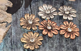 These mixed-metal inspirational flower sliders make beautiful focal beads. Etched words like “Love,” “Hope,” and “Joy” encircle a clear rhinestone center, creating a meaningful accent for bracelets and pendants. The two-hole construction ensures flat, stable placement in multi-strand designs. Great for bohemian, wellness, and affirmation jewelry, they pair well with leather, gemstones, and crystal accents. Durable alloy, lightweight, and eye-catching.
