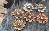 These mixed-metal inspirational flower sliders make beautiful focal beads. Etched words like “Love,” “Hope,” and “Joy” encircle a clear rhinestone center, creating a meaningful accent for bracelets and pendants. The two-hole construction ensures flat, stable placement in multi-strand designs. Great for bohemian, wellness, and affirmation jewelry, they pair well with leather, gemstones, and crystal accents. Durable alloy, lightweight, and eye-catching.