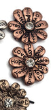 These affirmation flower 2 hole beads deliver both texture and sparkle. Words like “Peace,” “Dream,” and “Joy” wrap each petal, while a crystal center catches the light. Their two-hole slider structure supports flat, secure placement in chokers, bracelets, and multi-strand pieces. Perfect focal beads for bohemian and spiritual jewelry lines. Mix metals for a trendy, stacked look.
