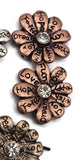 These affirmation flower 2 hole beads deliver both texture and sparkle. Words like “Peace,” “Dream,” and “Joy” wrap each petal, while a crystal center catches the light. Their two-hole slider structure supports flat, secure placement in chokers, bracelets, and multi-strand pieces. Perfect focal beads for bohemian and spiritual jewelry lines. Mix metals for a trendy, stacked look.