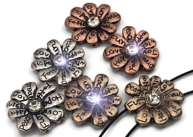 Spread positivity with these inspirational flower 2 hole slider beads. Each petal is engraved with uplifting words—love, hope, joy, faith, peace—and finished in silver, copper, or antique gold. A sparkling crystal center adds shine. The dual-hole slider design keeps them flat and secure, perfect as focal beads in bracelets, chokers, and necklaces. Ideal for boho, spiritual, and gift-worthy handmade jewelry.