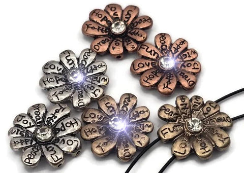 Spread positivity with these inspirational flower 2 hole slider beads. Each petal is engraved with uplifting words—love, hope, joy, faith, peace—and finished in silver, copper, or antique gold. A sparkling crystal center adds shine. The dual-hole slider design keeps them flat and secure, perfect as focal beads in bracelets, chokers, and necklaces. Ideal for boho, spiritual, and gift-worthy handmade jewelry.