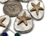 These starfish 2‑hole sliders deliver instant beach charm. Smooth oval “pebble” bases in silver host a textured gold starfish. The dual‑hole build keeps the focal flat on leather, cord, or chain—great for bracelets, chokers, earrings, and rings. Mixed‑metal, non‑tarnish finish coordinates with most findings. Set of five ready for quick listings.