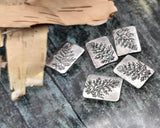 These botanical rectangle sliders add subtle texture to dainty designs. Each silver bead features a detailed leaf/branch motif. Small parallel holes fit fine materials only—beading wire, thin cord, or seed‑bead thread; avoid leather and chain. Use as focal beads or structured spacers in minimalist bracelets and necklaces. Durable, lightweight, non‑tarnish metal. Pack of five.