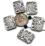 Antique silver branch leaf 2 hole slider beads. Rectangular plaque with raised botanical/fern design. Small dual holes fit fine beading wire, FireLine, Power Pro, or 0.5–0.8 mm cord; not for leather or chain. Perfect focal beads for delicate bracelets, chokers, and pendant necklaces. Lightweight, non‑tarnish metal. Set of 5 nature beads for woodland, cottagecore, and minimalist jewelry.