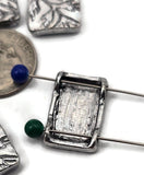 These silver plant branch slider beads bring subtle nature style. Rectangular two‑hole design with small channels for thin cord and beading wire only. Crisp etched leaves look great with gemstone chips and seed beads. Use as center focals or structured spacers. Tarnish‑resistant metal. Set of 5 foliage beads.