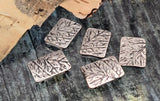 Nature‑theme silver metal beads with raised leaf and branch pattern. Rectangular, slightly curved profile sits comfortably on the wrist. Two tiny parallel holes align thin strands and prevent twisting. Best for 0.015–0.018" beading wire or braided thread. Great for minimalist jewelry, bridesmaid gifts, and everyday wear. Five artisan 2‑hole beads included.