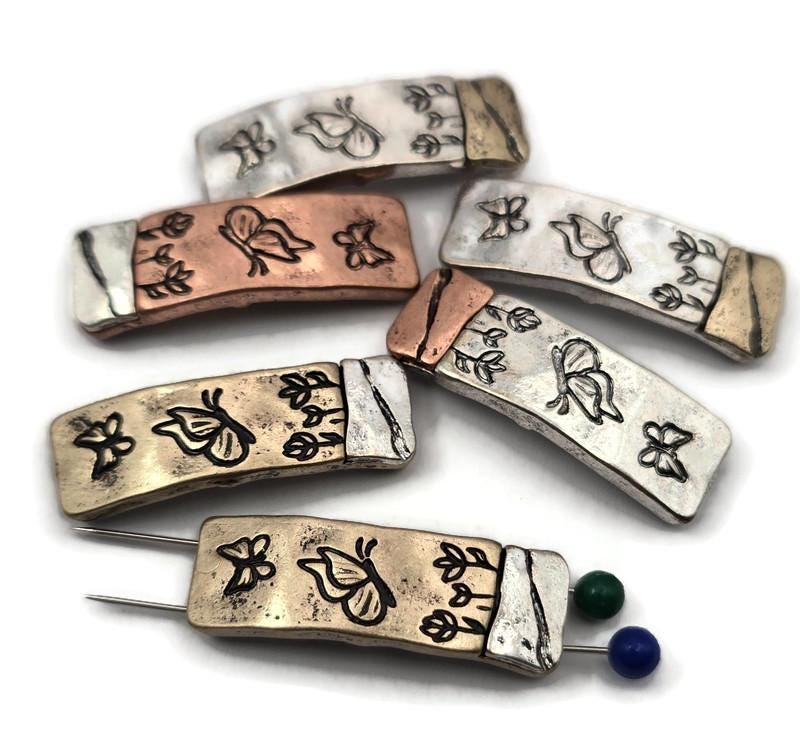Butterfly 2‑hole slider beads for bracelet and necklace making. Each metal slider has two holes on each side for double‑strand stringing, perfect spacers for wide cuff bracelets, layered chokers, and structured designs. Use both hole sets or one for flexible layouts. Rustic mixed‑metal finishes pair with leather, cord, and gemstone beads. Unique jewelry findings for boho, cottagecore, and nature‑inspired DIY projects.