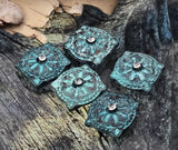 Add drama with these square patina slider beads—textured mandala face, faceted crystal accent, and two parallel holes for a tidy, centered look. Each bead features an artisan turquoise verdigris finish that photographs beautifully and stands out on product pages. Ideal focal beads and metal beads for boutique designs, statement bracelets, and curated gift sets. Handcrafted vibe with elevated shine.