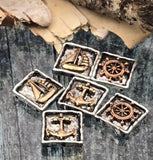 These square nautical sliders showcase detailed maritime icons framed by textured borders. Antiqued silver contrasts with bronze highlights to emphasize each design. They read sculptural and substantial, perfect for focal beads in bracelets and simple pendant features for necklaces. Ideal unique beads for beach, coastal, sailor, or travel‑inspired collections. Purposeful distressing enhances the old‑world, sea‑worn character.