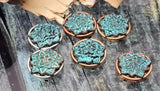 These unique beads bring a touch of bohemian charm with their lotus flower motif and vibrant turquoise patina. Set in round antique silver, copper, or brass frames, they make eye-catching focal beads. Two parallel holes help beads sit neatly in finished designs. Perfect for bracelet designs and pendant features on necklaces, offering a dimensional texture and rich color.