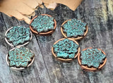 Craft with character using these round lotus flower 2 hole slider beads. The verdigris patina highlights the intricate floral design, set in an antiqued metal frame. Use as a hero bead for bracelet styles or as a pendant centerpiece on necklaces. The mixed-metal settings and dimensional texture make these unique beads perfect focal beads for boho, nature, or vintage-inspired collections.
