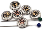 Animal paw print beads with heart detail. Two-hole sliders in antique silver with copper or brass paw accents. The hammered texture and dark recesses create a bold, readable design that photographs beautifully. Use as focal beads for bracelet styles and pendant centers. Search phrases: paw bead slider, dog bead, cat bead, pet lover jewelry supplies, mixed metal paw bead.