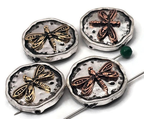 Dragonfly beads, 2 hole slider style, on rustic round coin settings. Antiqued silver backgrounds with raised copper or brass dragonflies. Textured edges and hammered surface add depth that photographs beautifully. Unique focal beads for bracelet designs and simple necklace pendants. Keywords: dragonfly bead, insect bead, nature bead, mixed metal slider bead, boho jewelry supplies, round coin bead.