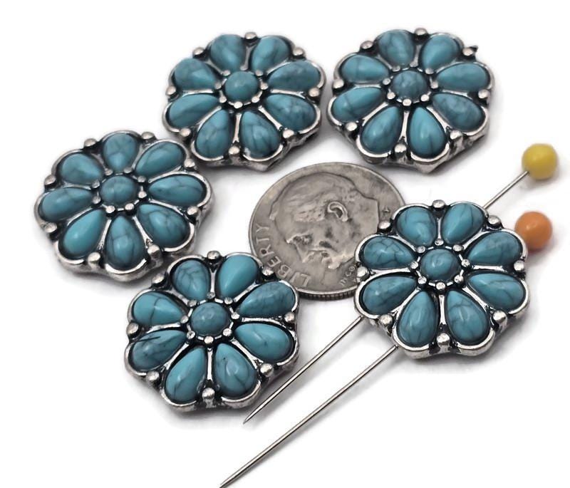 Western flower 2‑hole slider beads with turquoise‑look petals and antique silver frames. Use as focal beads, spacer beads, or metal beads in leather cuffs, loom bracelets, and hatbands. Dual holes keep two strands aligned for flat, stable designs. Ideal findings for Southwestern jewelry making, bolo ties, and chokers. Great for DIY kits and concho‑style projects that need a bold centerpiece.