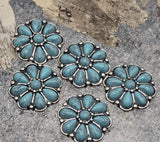 Two‑hole flower slider beads with bright turquoise cabochons and beaded silver rims. Perfect as focal beads for leather cuffs, hatbands, and loom bracelets. The dual‑hole construction stabilizes two strands to prevent rotation. Great metal beads and spacer beads for Southwestern jewelry making, DIY kits, and concho belt projects. Essential findings for western style.