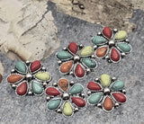 Brighten your designs with multicolor 2-hole flower slider beads. The concho-style centerpiece doubles as focal bead and wide spacer bead. Dual holes thread two strands for straight alignment—perfect for leather bracelets, loom work, and stacked chokers. Durable metal beads with dotted silver edges. Essential Southwestern jewelry supplies and DIY findings for Western-themed projects.