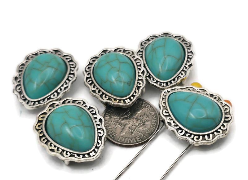Turquoise teardrop 2-hole slider beads with antique silver frames. Use as focal beads for bracelets, necklace beads for chokers, or statement beads for hatbands. Dual holes keep two strands aligned—perfect for leather cuffs, loom bands, and peyote strips. Ideal jewelry making beads and beads for beading when you want Southwestern style fast. Great for DIY bracelets, necklaces, and Western accessories.