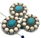 Large concho 2 hole slider beads with turquoise center and ivory cabochon border in antique silver. Round rosette focal beads for bracelets and necklaces. Small parallel holes fit fine beading wire, FireLine, or micro cord (not leather/chain). Great statement components for boho, Southwestern, festival, and cowgirl‑chic jewelry. Bulk wholesale metal supplies; unique spacer/filler DIY parts. Set of 3.