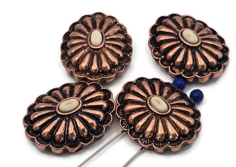 Antique copper concho 2 hole slider beads with raised scalloped petals and cream oval cabochon center. Large round rosette focal beads for bracelets and necklaces. True slide double‑strand design; small parallel holes fit fine beading wire, FireLine, or micro cord (not leather/chain). Jewelry making supplies, components parts, artisan beads, unique spacer filler, bulk wholesale metal, cheap sliderbeads.
