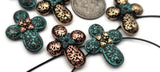 These baroque cross‑shaped sliders feature rich filigree texture and a petite star‑flower cap. True double‑strand components with small holes that keep strands flat and centered. Use as focal beads or structured spacers in bracelet stacks and pendant bars. Perfect for artisan beading projects, festival collections, and giftable DIY kits.