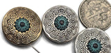 Bohemian round sliders featuring concentric circles and a teal patina center. Two small holes run side by side for easy double‑strand stringing. Great for crafting bracelets, anklets, and layered chokers. Mixed‑metal palette coordinates with sterling, brass, or copper findings and suits earth‑tone gemstones.