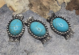 Western oval concho sliders with faux turquoise offer an easy focal for 2-strand designs. Silver metal finish, dotted border, and rustic texture elevate bracelets, necklaces, and earrings. The double holes and back guide loops help guide your stringing material for stable, symmetrical results. Use as spacer, connector, or centerpiece with seed beads or mixed beads. Distinctive metal beads and beading components; lead and nickel compliant.