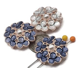 Make fresh, feminine jewelry with these floral 2 hole slider beads in bright gold metal. Swirled enamel petals—deep blue and soft sky—surround a luminous faux pearl. Parallel holes plus guide loops on the back stabilize strands for polished bracelets and necklace pendants. Perfect as connector or spacer focals; great with seed beads for pattern and spacing. Distinctive metal beads and beading components; lead and nickel compliant.