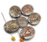 These oval 2 hole slider beads bring message style to your designs: light pewter metal, layered gold/copper hearts, and an engraved “LOVE.” Build a bracelet by centering one slider and tapering seed beads toward the clasp, or create a pendant by attaching chain on both sides and adding a small charm drop. Versatile spacer and connector components; reliable jewelry findings and supplies for beading and crafting.