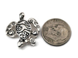 These silver sea turtle slider beads bring a playful nautical vibe to your projects. Use as a bracelet focal, a necklace centerpiece, or lightweight earring focal. Add seed beads, bugle, crystals, gemstone chips, or other metallic beads as fillers to build rhythm and texture. Essential 2 hole slider beads, beading components, and findings for ocean jewelry, beach vacations, and craft fair kits. Durable metal beads; easy to coordinate with blues, aquas, and neutrals.
