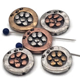 Round paw print 2‑hole slider beads with a dimensional center paw and tiny rim prints. Mixed‑metal finishes—silver, copper, and brass—make styling simple. Use as a sweet focal in dog mom bracelets, pet memorial pieces, and adoption fundraiser gifts. Pair with seed beads, gemstones, or crystals for stackable bracelets, charm chokers, and anklets that celebrate your favorite companion.