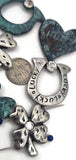 Design lucky charm jewelry with antique silver clovers and a teal patina heart focal. Use clovers as 2 hole slider beads, spacer bars, or bracelet centerpieces, and the open clover ring as a pendant connector. Mix with turquoise howlite, pearls, or seed beads for Celtic, cottagecore, or boho styles. Great for stacked bracelets, pendant bars, and giftable DIY kits.