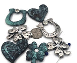 Create lucky charm jewelry with these clover sliders and matching open ring connector. The textured metal and oxidized finish give vintage appeal, while the teal heart adds color. Ideal as focal sliders, structured spacers, and bracelet centerpiece parts. Build pendant bars, layered chokers, and anklets for giftable sets and craft‑fair bestsellers.