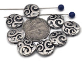 Round coin 2‑hole slider beads with bold swirl engraving in antique silver. Oxidized recesses make the pattern pop, giving bracelets a classic Celtic/boho vibe. Use as bracelet centerpiece, spacer bar, or pendant bar charm for layered chokers. Great fillers for stackable sets, bead‑loom cuffs, and men’s/unisex designs. Mix with onyx, hematite, turquoise howlite, or crystal for photo‑ready jewelry.