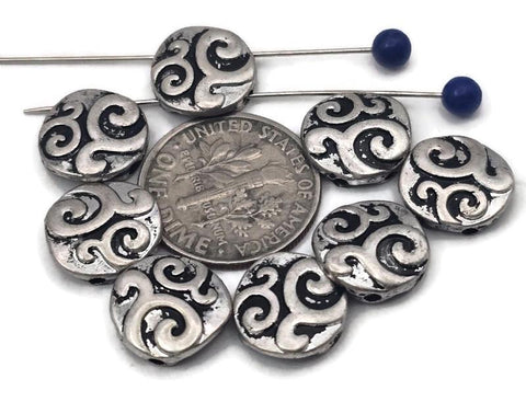 Round coin 2‑hole slider beads with bold swirl engraving in antique silver. Oxidized recesses make the pattern pop, giving bracelets a classic Celtic/boho vibe. Use as bracelet centerpiece, spacer bar, or pendant bar charm for layered chokers. Great fillers for stackable sets, bead‑loom cuffs, and men’s/unisex designs. Mix with onyx, hematite, turquoise howlite, or crystal for photo‑ready jewelry.