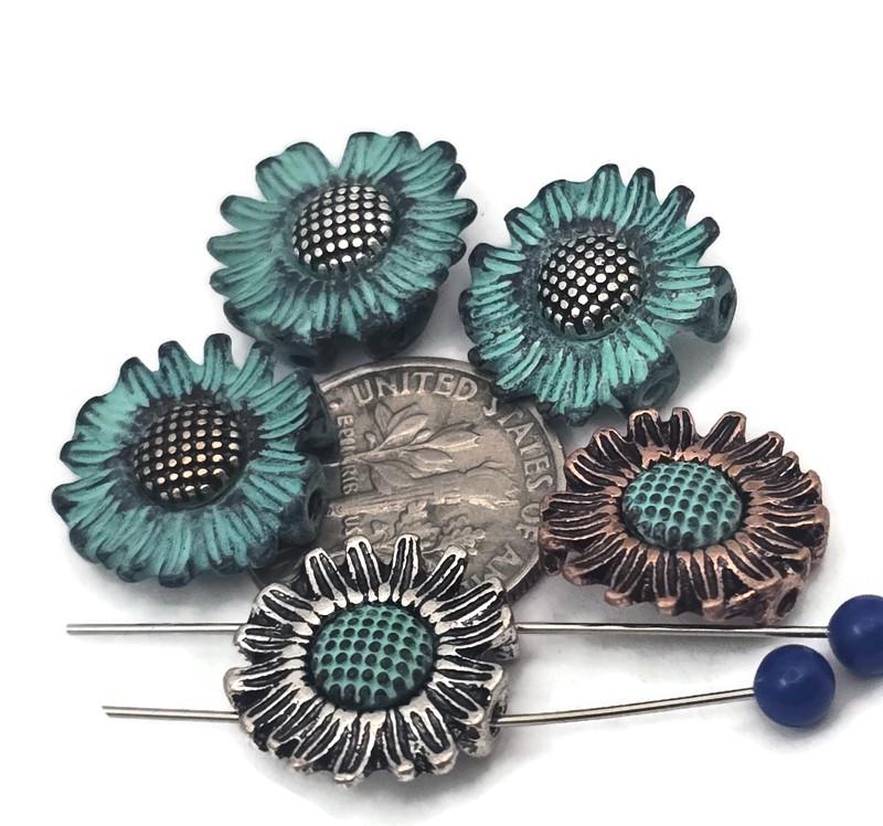 Sunflower 2‑hole slider beads with dimensional petals and dotted centers. Mixed finishes—teal verdigris with antique silver or rustic copper—create bold garden style. Use as bracelet centerpiece, spacer bar, or pendant bar charm for layered chokers. Perfect for cottagecore, boho, and summer jewelry. Pair with pearls, amazonite, or crystal for cheerful, giftable sets that photograph beautifully.