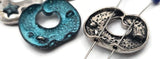 Engraved Wisdom donut sliders feature vintage silver tone, teal patina accents, and a faceted crystal. Designed as double‑strand connectors, these inspirational beads are perfect as bracelet focals, filler beads, or pendant connectors. Great for self‑care jewelry, friendship gifts, and meditation‑themed collections.