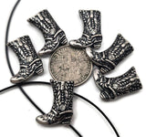 Western boot 2‑hole slider beads in antique silver finish with detailed stitching and spur accents. Perfect as bracelet focal beads, double‑strand spacers, or pendant bar centerpieces in country, rodeo, or cowgirl jewelry. Use these cowboy boot beads to design rustic, western bracelets, chokers, or anklets with turquoise howlite, jasper, or hematite. Now sold in packages of six.