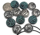 Celtic knot 2‑hole slider beads in antique silver and teal verdigris. These intricate round beads feature raised interlacing designs framed by rope‑style borders. Perfect as bracelet focal sliders, double‑strand spacers, or pendant bar connectors in boho and heritage‑inspired jewelry. Durable yet lightweight for chokers, cuffs, and necklaces that celebrate ancient craftsmanship and timeless Celtic symbolism.