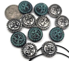 Celtic knot 2‑hole slider beads in antique silver and teal verdigris. These intricate round beads feature raised interlacing designs framed by rope‑style borders. Perfect as bracelet focal sliders, double‑strand spacers, or pendant bar connectors in boho and heritage‑inspired jewelry. Durable yet lightweight for chokers, cuffs, and necklaces that celebrate ancient craftsmanship and timeless Celtic symbolism.