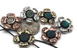 Flower 2‑hole slider beads engraved with inspiring words—Faith, Hope, Love, Joy. Each bead has a spiral center with a soft teal patina and mixed metallic petals in antique silver, brass, or copper. Perfect for double‑strand bracelets, chokers, or pendant bars. Symbolic and versatile, these floral beads add warmth and meaning to both boho and inspirational jewelry collections.