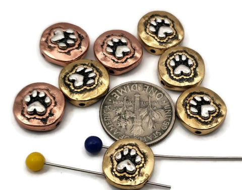 These mixed‑metal paw print 2‑hole slider beads feature raised silver paw designs in antique copper and brass finishes. Perfect for double‑strand bracelets, chokers, or multi‑strand necklaces, they add warmth, contrast, and character to pet‑themed jewelry. Use them as focal beads, spacer bars, or pendant connectors for designs celebrating dog and cat lovers.