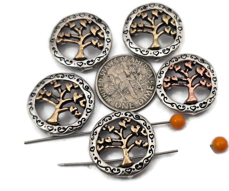 Make nature‑inspired jewelry with these silver eternal life tree 2‑hole slider beads. The dual channels keep strands aligned, making them perfect focal beads for bracelet designs or pendants for necklaces. Use as spacer bars, slide beads, or double strand beads between pearls, gemstones, seed beads, chips, or tribal silver beads. These metal beads also mix well with duo beads for structured patterns. Ideal eternal life beads and tree beads for boho, rustic, and spiritual collections.